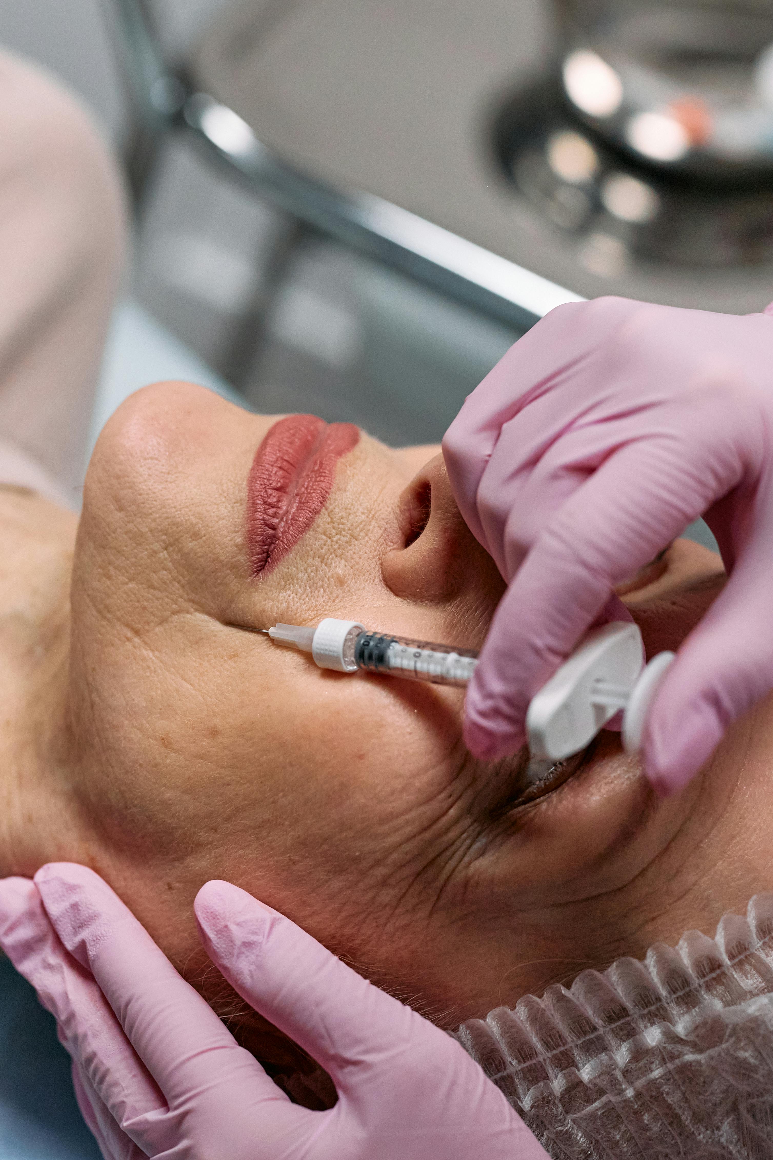 Woman having injection procedure into her cheek