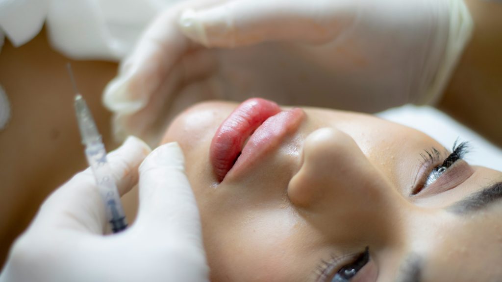 Woman having a lip filler procedure